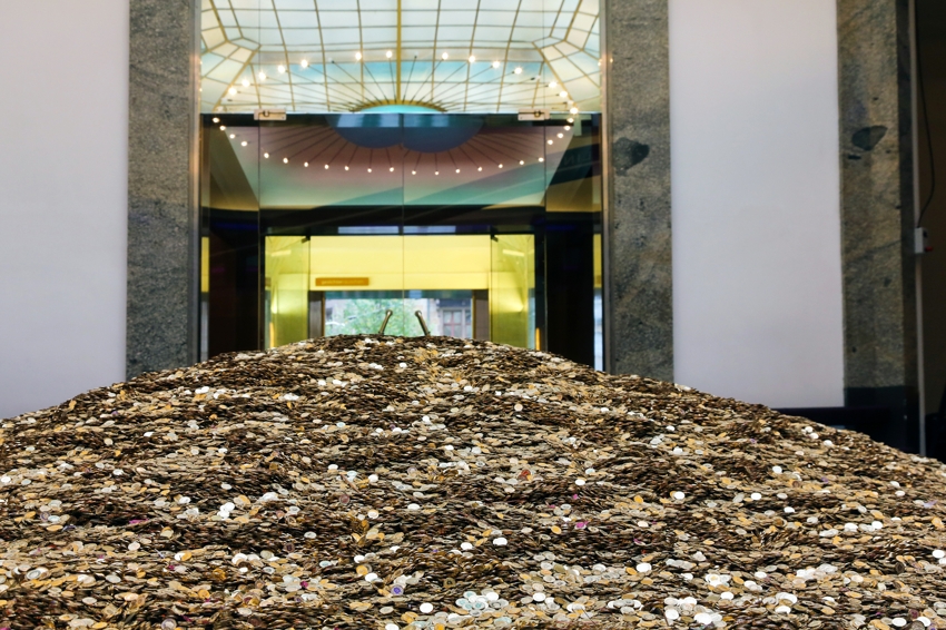 A very large pile of coins in a nice looking bank. For investing podcast Money For the Rest of Us by David Stein 