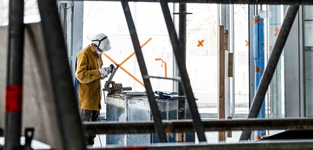 Construction worker cutting metal