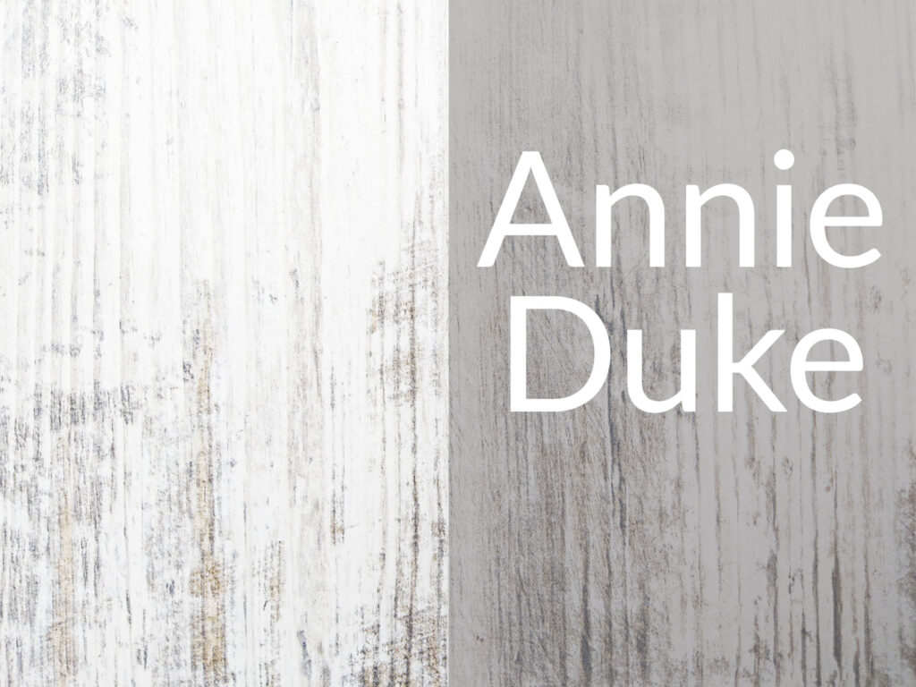 Painted wood background with caption "Annie Duke"