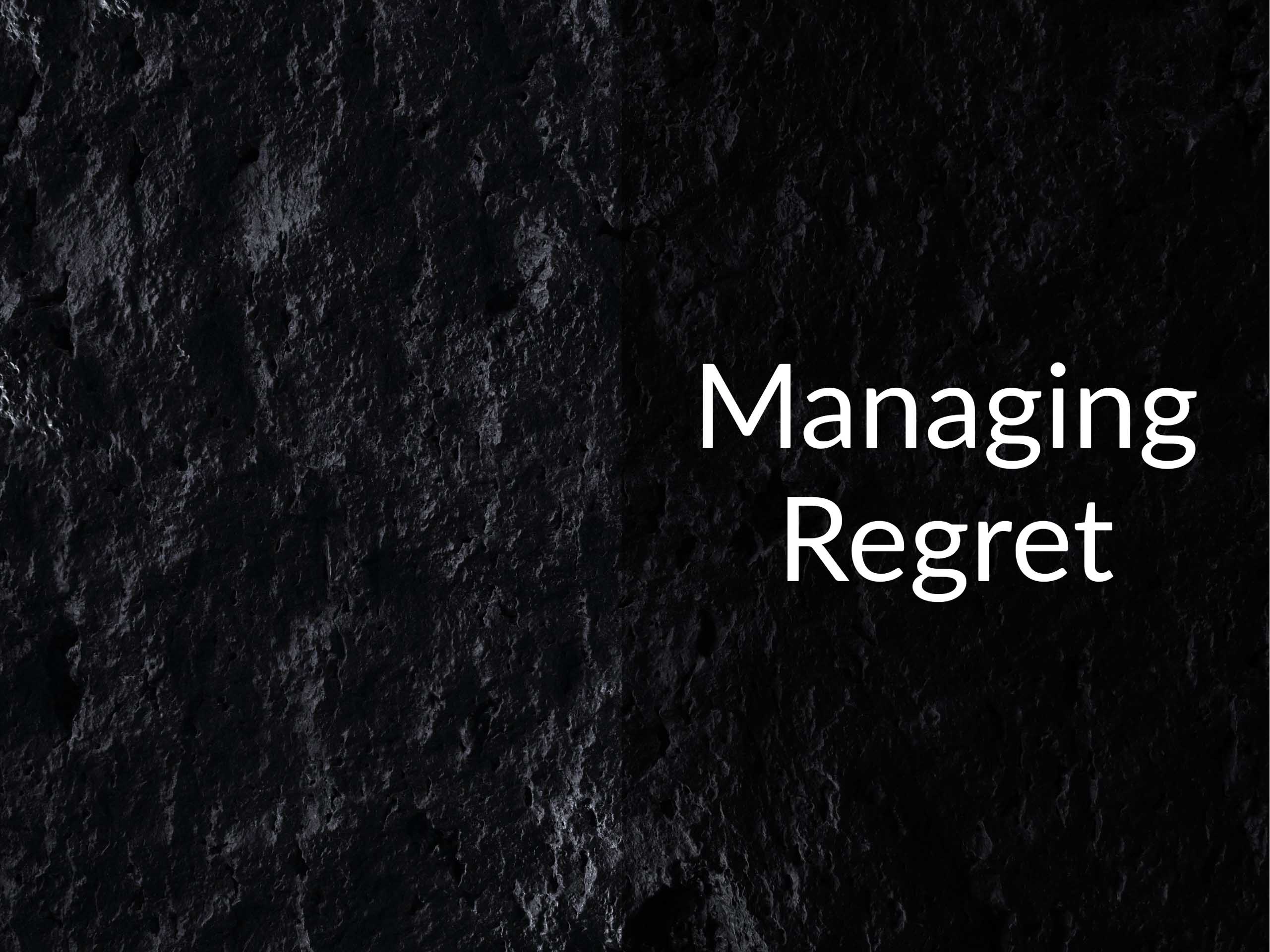 Dark lava rock with the caption "Managing Regrets"